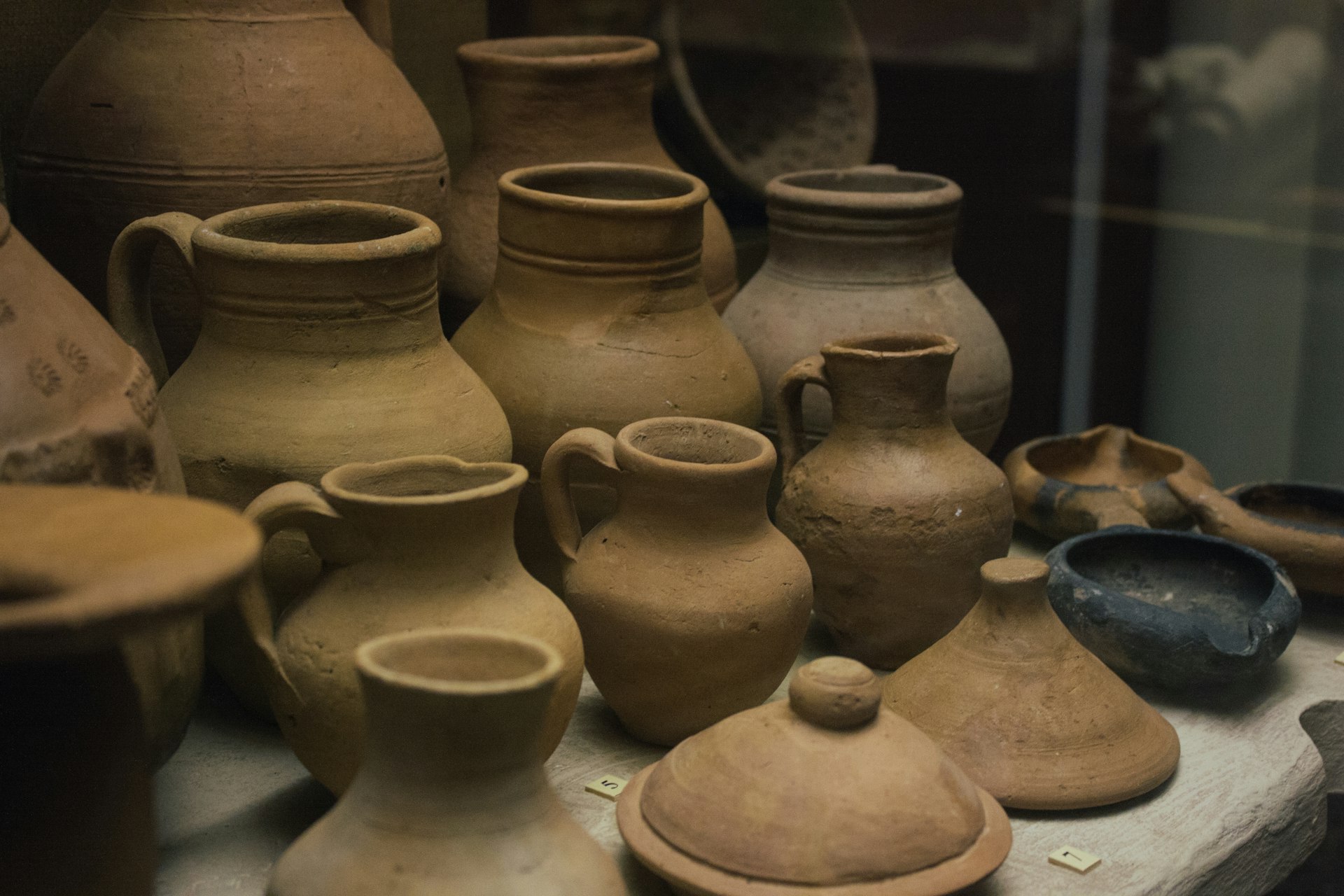 lots of brown vases antique object a table topped with lots of brown vases